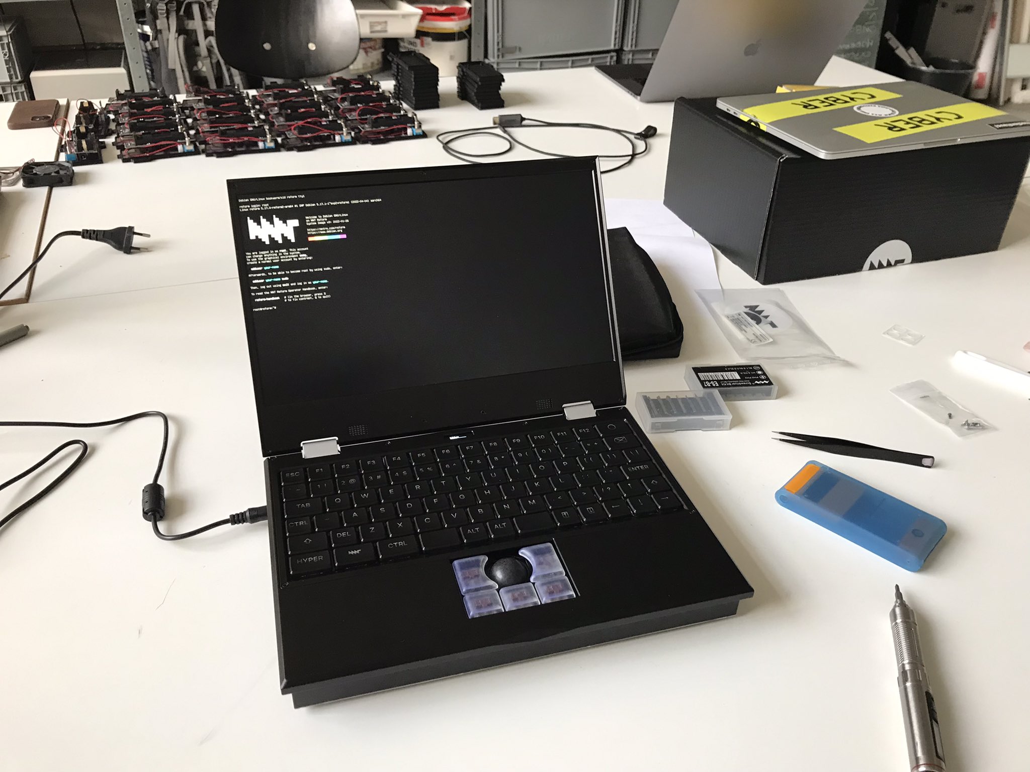 photograph of an assembled MNT Reform open-hardware laptop by @minut_e, depicted within some creative chaos™ in medienhaus/ lab at Berlin University of the Arts