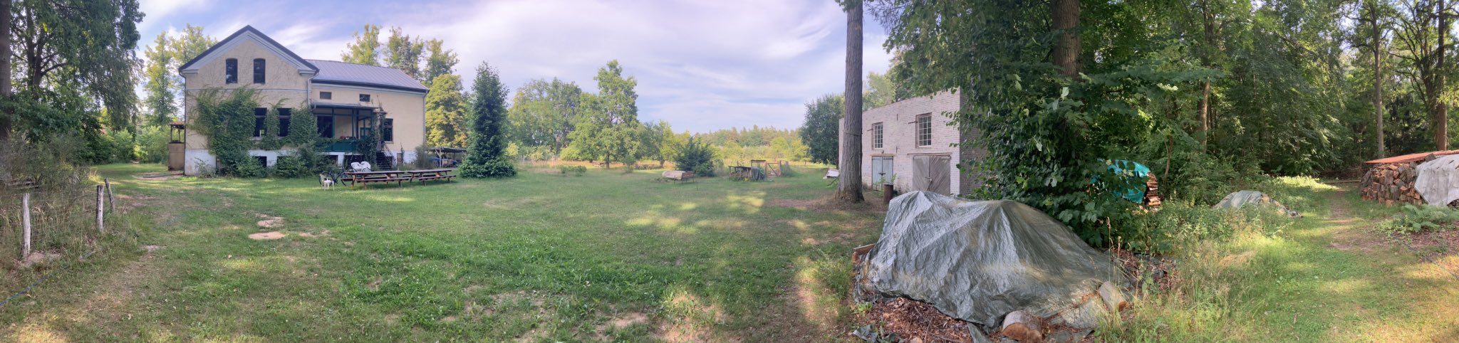 very wide panorama photograph taken in the garden of Stechlin Institut in Neuroofen; sun is shining, the weather is sweet